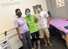 people smiling while wearing face masks.
